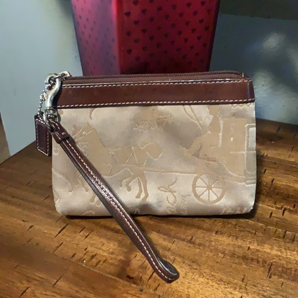 Brown and tan coach wristlet.